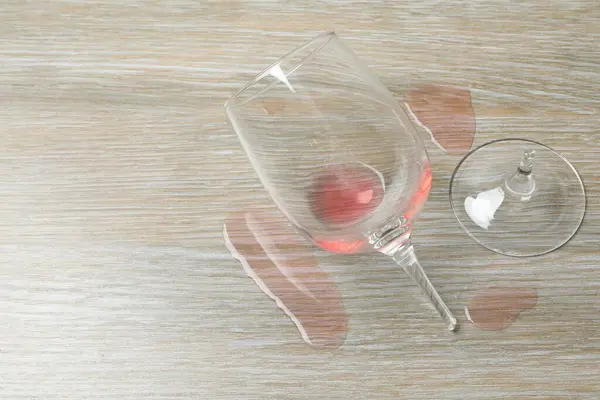 Glass of wine broken on the table