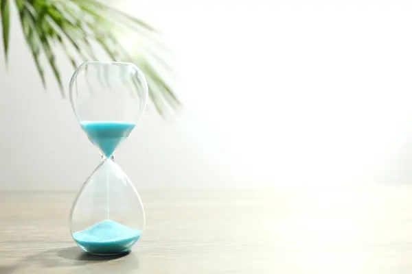 Modern hourglass on table. Hourglass time concept for business deadline, urgency and outcome of time.