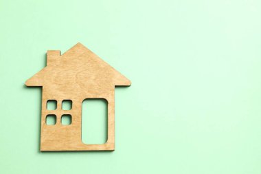 Wooden house on color background clipart