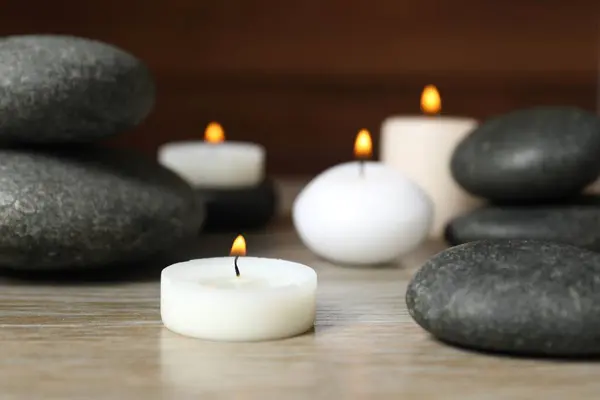 Beautiful Composition Burning Wax Candles Stones Tabl Stock Photo