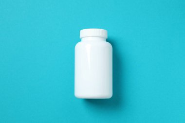 White bottle on a blue background