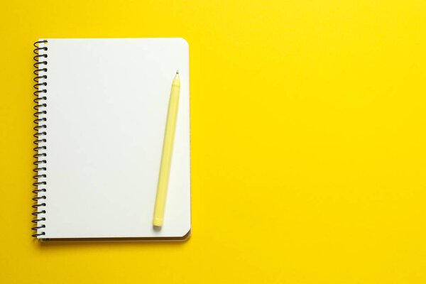 Flat lay with notebook on color background, top view