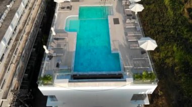 Çatı havuzu, bar, turkuaz, Karon, otel, şemsiye ve güneşlik manzarası. Gün batımı ve güzel doğa, dağlar ve tepeler, turistler için eğlence, adada popüler oteller. Yüksek kalite