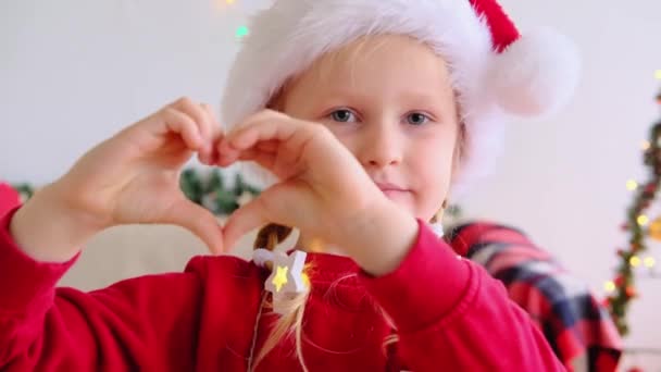 Happy Little Girl Xmas Cap Make Finger Heart Look Camera — Stock Video