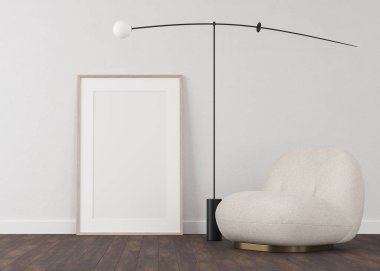 Açık alçı duvar ve ahşap zeminden yapılmış 3 boyutlu çerçeveler. Duvardaki beyaz çerçeveler. Koltuk ve zemin lambası