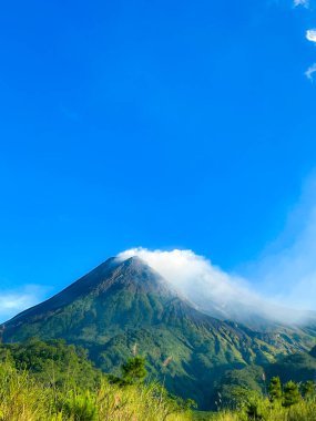 beautiful view of mount merapi against blue sky and white cloud clipart