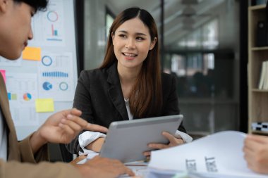 Fon yöneticileri takım danışmanlığı ve dijital tablet üzerinden yatırım borsası analizi hakkında tartışmalar.