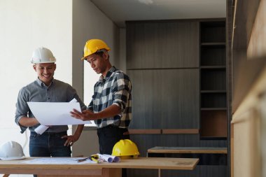 Profesyonel mimar tasarımcı yapı mühendisi takım arkadaşları bina tasarım projesini tartışıyor.
