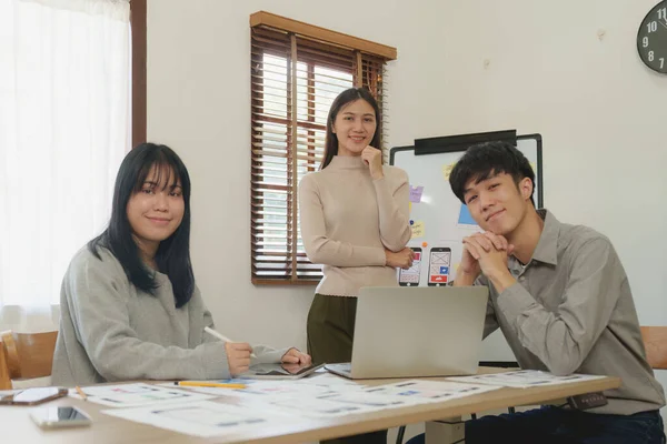 Young Asian Start up new business working at creative office. Modern start-up business team. Co-workers ui, ux startup small business.