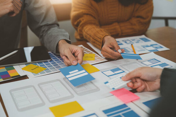 Young Asian Start up new business working at creative office. Modern start-up business team. Co-workers ui, ux startup small business.