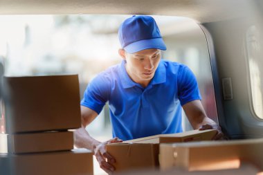 Asian courier with parcel and delivery logistic concept. Delivery man holding parcel box.