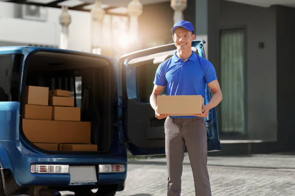 Asian courier with parcel and delivery logistic concept. Delivery man holding the parcel.