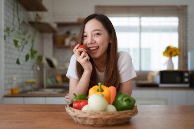 Portrait of beautiful young asian woman making salad at home. cooking food and Lifestyle moment.