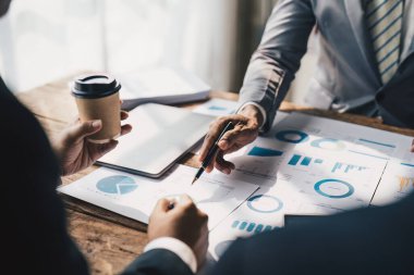 Close up of Diverse colleagues gather brainstorm discuss financial statistics at office meeting. finance, teamwork concept.