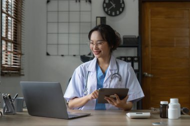Doctor holding digital tablet at clinic. Medical technology concept