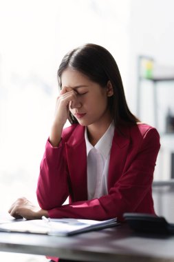 Stressed Business woman checking budget of company, taxes, bank account balance and calculating expenses at office.