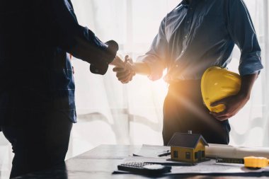 Architecture or Civil engineer analyze handshake making modern construction. industry professional team and engineer concept.