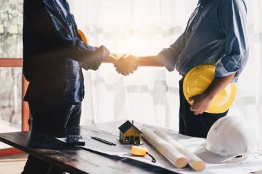 Architecture or Civil engineer analyze handshake making modern construction. industry professional team and engineer concept.