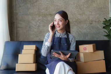 Beautiful Businesswoman start small business. A woman works from home delivering parcels online. Entrepreneurs, SME delivery concept.