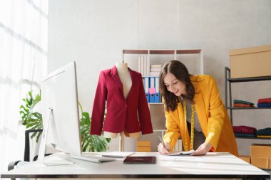 Beautiful young professional stylist working at design studio interior. fashion designer concept.