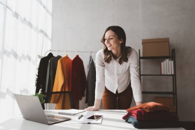 Beautiful young professional stylist working at design studio interior. fashion designer concept.