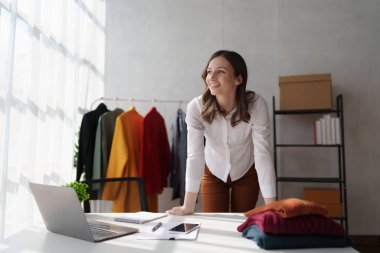 Beautiful young professional stylist working at design studio interior. fashion designer concept.