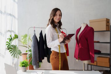 Beautiful young professional stylist working at design studio interior. fashion designer concept.