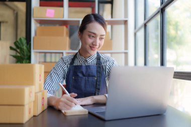 Beautiful Businesswoman start small business. A woman works from home delivering parcels online. Entrepreneurs, SME delivery concept.