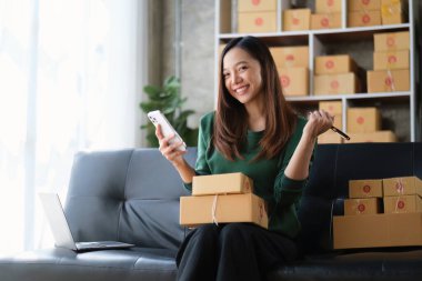 Beautiful Businesswoman start small business. A woman works from home delivering parcels online. Entrepreneurs, SME delivery concept.