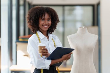 Portrait of young african american woman fashion designer stylish working at fashion studio