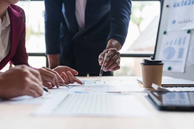 Close up Business people analysing financial report. Consulting with paperwork financial document