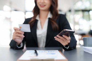 Woman makes a purchase on the smart phone with credit card, online payment, shopping online, e-commerce, internet banking concept.