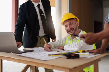 Civil Construction team working at renovate construction site. architectural plan, engineer sketching a construction project, green energy concept