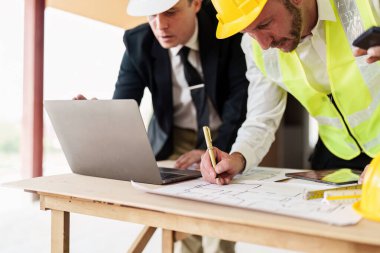 Civil Construction team working at renovate construction site. architectural plan, engineer sketching a construction project, green energy concept