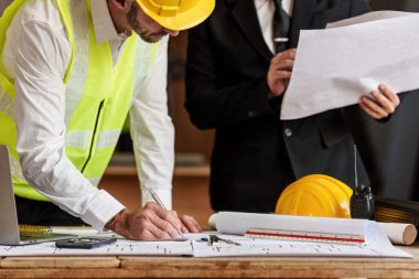 Civil Construction team working at renovate construction site. architectural plan, engineer sketching a construction project, green energy concept