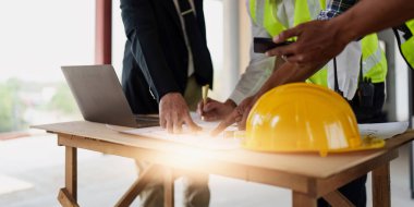 Civil Construction team working at renovate construction site. architectural plan, engineer sketching a construction project, green energy concept