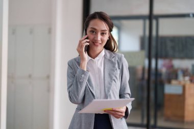 Beautiful business woman talking on the mobile phone. Management, planning and networking phone call concept