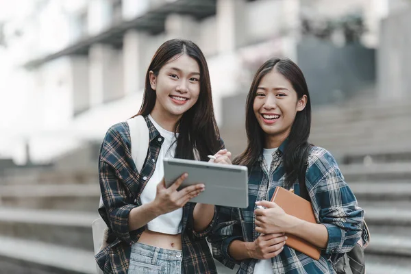 stock image Young Asian woman college student with friends at outdoors. College student working on the college campus, education, school, study.