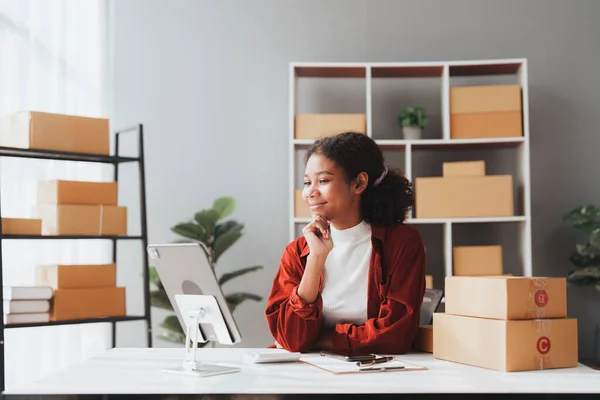 stock image American African entrepreneur smile and use a tablet to live stream. Successful SME entrepreneur concept.