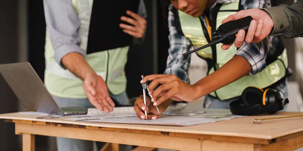 stock image Architecture and engineering team working together at construction site office. Industrial people and manufacturing labor concept.