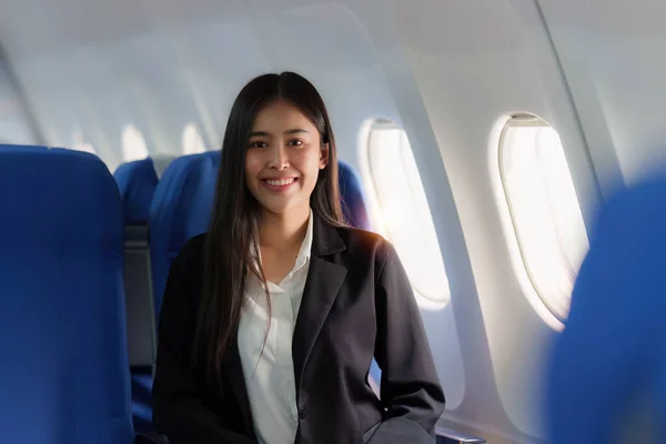 Beautiful Asian business woman happy and smile in luxury flight. working, travel, business concept.