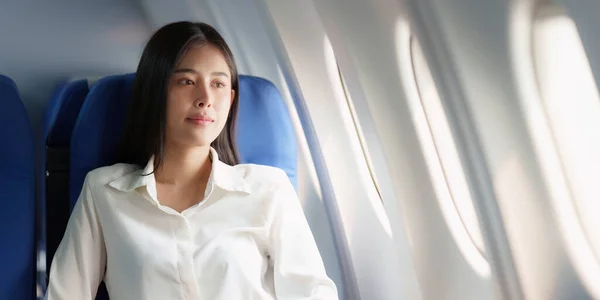 Beautiful Asian business woman happy and smile in luxury flight. working, travel, business concept.