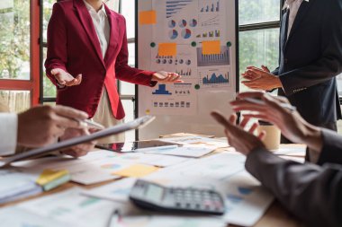 Close up of Diverse colleagues gather brainstorm discuss financial statistics at office meeting. finance, teamwork, Big data Graphs Charts concept.