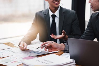 Close up of Diverse colleagues gather brainstorm discuss financial statistics at office meeting. finance, teamwork, Big data Graphs Charts concept.
