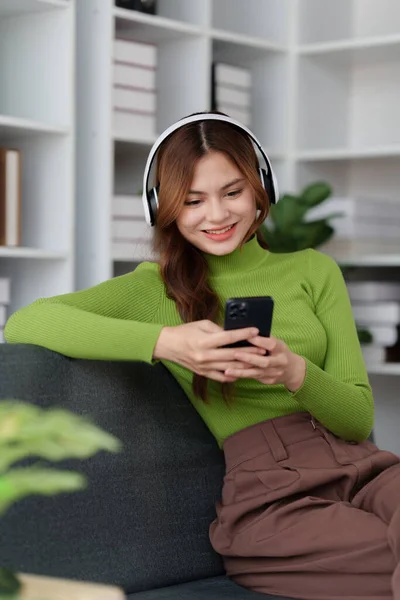 stock image Attractive Asian woman resting comfortable living room and using mobile phone, Relax, Sofa, Lifestyle.