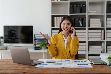 Beautiful business woman talking on the mobile phone. Management, planning and networking phone call concept.