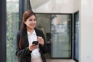 Beautiful business woman talking on the mobile phone. Management, planning and networking phone call concept.
