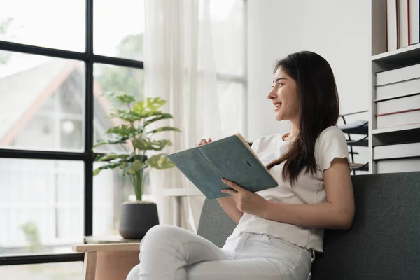 stock image Attractive Asian woman resting comfortable living room and reading book, Relax, Sofa, Lifestyle.