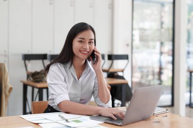 Beautiful business woman talking on the mobile phone. Management, planning and networking phone call concept.