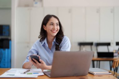 Beautiful Businesswoman completes KYC using an online banking program in order to open a digital savings account. The definition of cyber security.